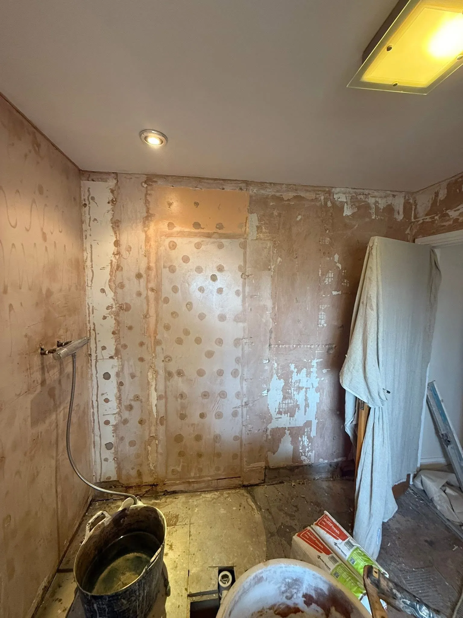 Freshly skimmed walls in a bathroom mid-renovation